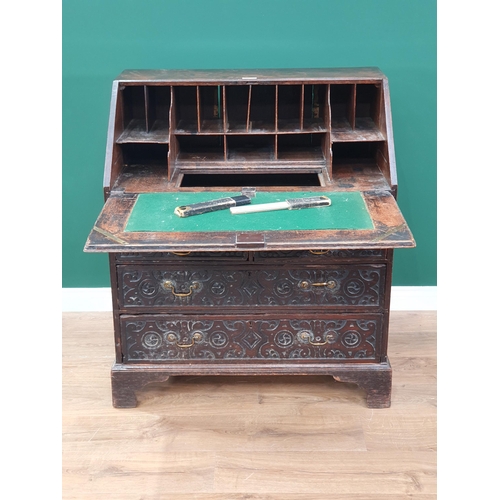 657 - An antique carved oak Bureau fitted two short and two long drawers 3ft 4in H x 2ft 11in W