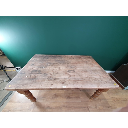 711 - A Victorian pine Kitchen Table on turned supports 4ft 10in W x 2ft 6in H