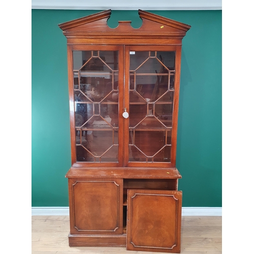 723 - A reproduction mahogany glazed Bookcase with a pair of astragal glazed doors above a pair of cupboar... 