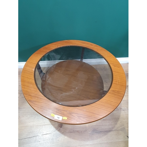 748 - A mid century teak Circular glass topped two tier Coffee Table.