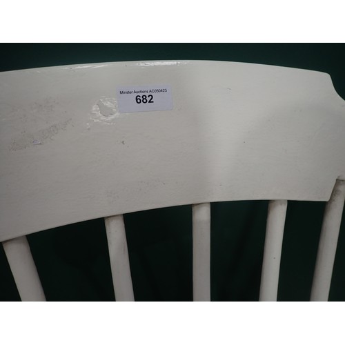 682 - A white painted Rocking Elbow Chair with spindle back and baluster supports