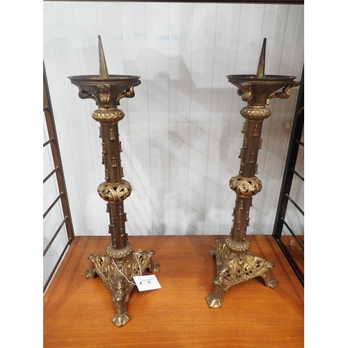 83 - A pair of large gilt metal gothic style Pricket Candlesticks on triangular bases having paw feet, 20... 