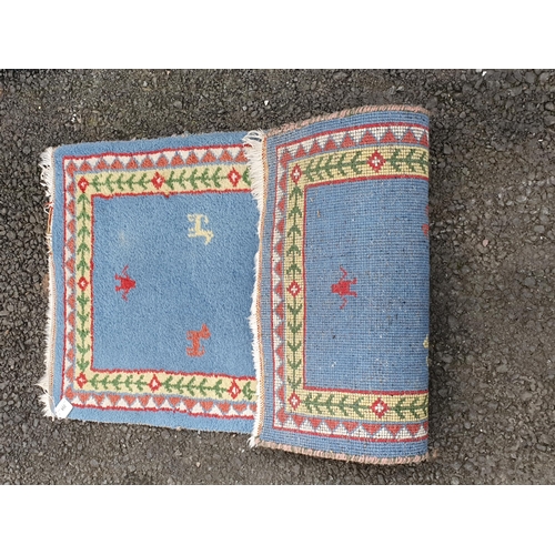 852 - A small light blue ground Rug with animal motifs