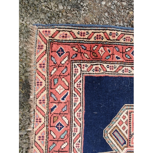 853 - A blue ground multi-border Persian Rug with three central motifs, 5ft 7in x 4ft 1in and another red ... 