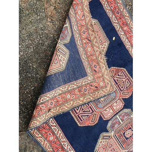 853 - A blue ground multi-border Persian Rug with three central motifs, 5ft 7in x 4ft 1in and another red ... 