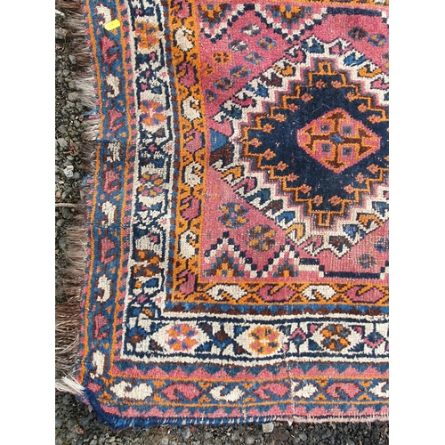 853 - A blue ground multi-border Persian Rug with three central motifs, 5ft 7in x 4ft 1in and another red ... 