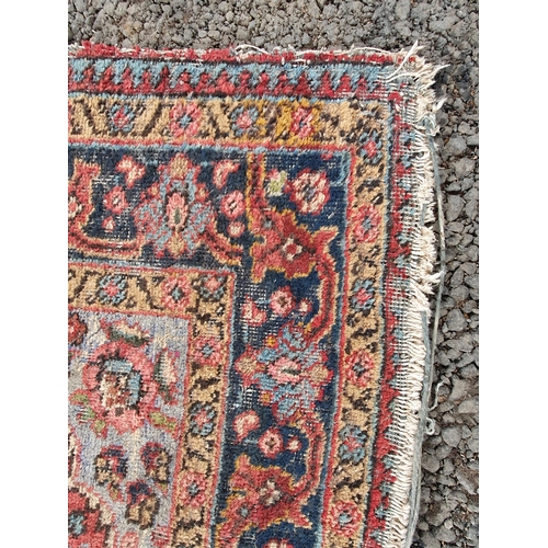 854 - A red ground Rug with floral multi-borders and a central floral motif, 6ft 1in x 4ft 3in