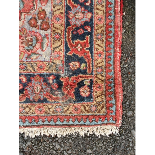 854 - A red ground Rug with floral multi-borders and a central floral motif, 6ft 1in x 4ft 3in