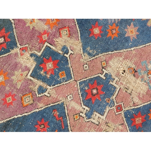 855 - A large blue ground Rug with multi-borders and patterns to the centre, 10ft 5in x 5ft 7in