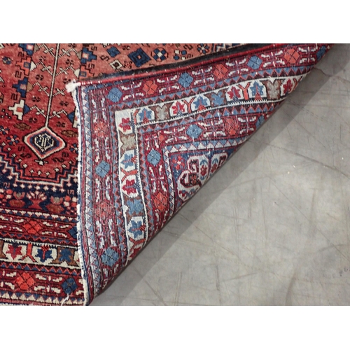 91 - A multi-bordered Persian Rug with central diamond lozenge having fine detail on a red and blue groun... 