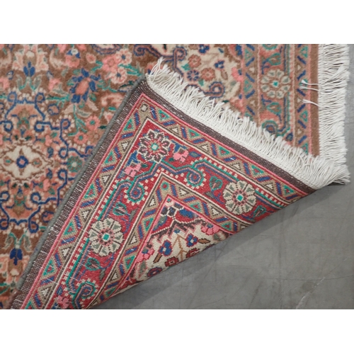 93 - A small bordered Persian Rug with all over floral design on a pink, brown and camel ground