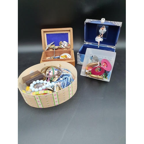 95 - An eastern carved wood Jewel Box and three others containing Costume Jewellery, enamel Badges, etc