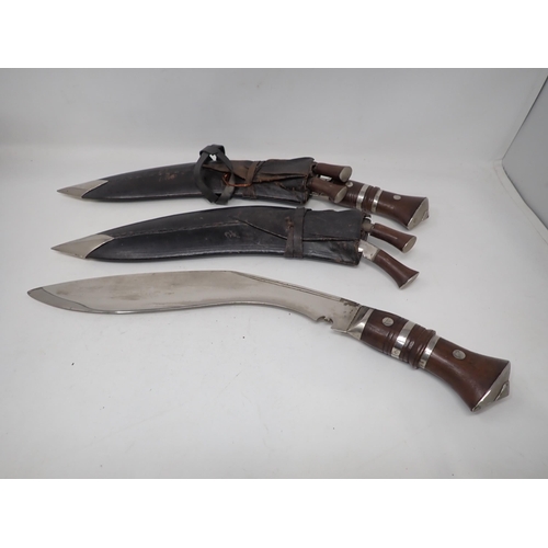 98 - A pair of Eastern Kukris, each with two smaller Knives, in scabbards, having white metal mounts, 17i... 