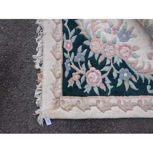 296 - A large Beige ground rug with a floral boarder and central floral motif