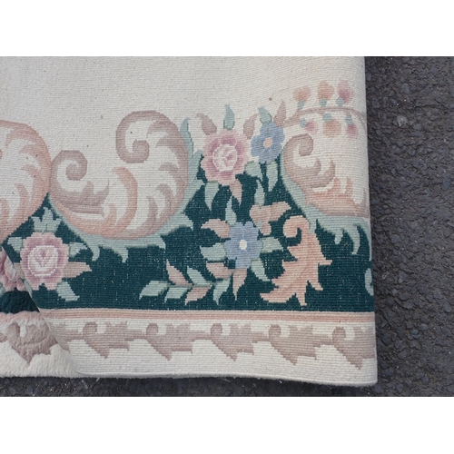 296 - A large Beige ground rug with a floral boarder and central floral motif