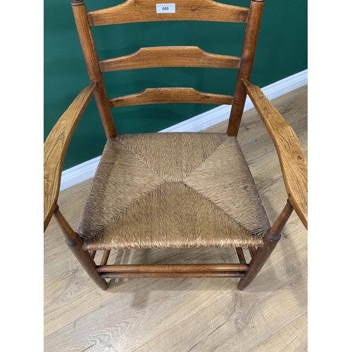 680 - A 19th Century ash Ladder back Elbow Chair with caned seat on turned supports and stretchers