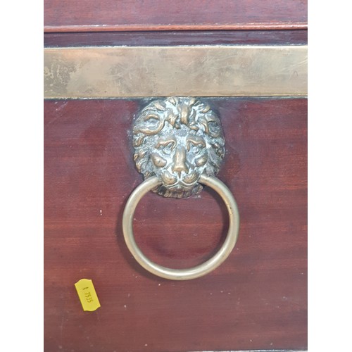 12 - A George III  mahogany brass bound Wine Cooler with lion mask and ring handles on squared tapering s... 