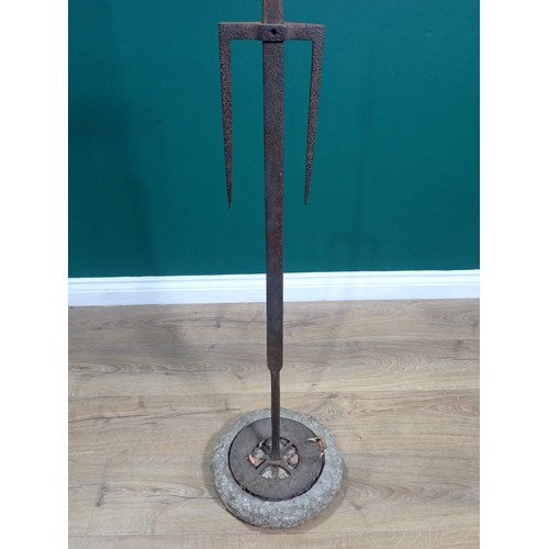 49 - An early iron Spit with adjustable two prong fork on tapering shaft, circular base, mounted on an as... 