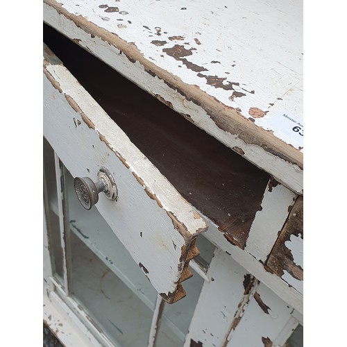 631 - A white painted glazed Cabinet with raised upper section above two drawers and two glazed panelled d... 