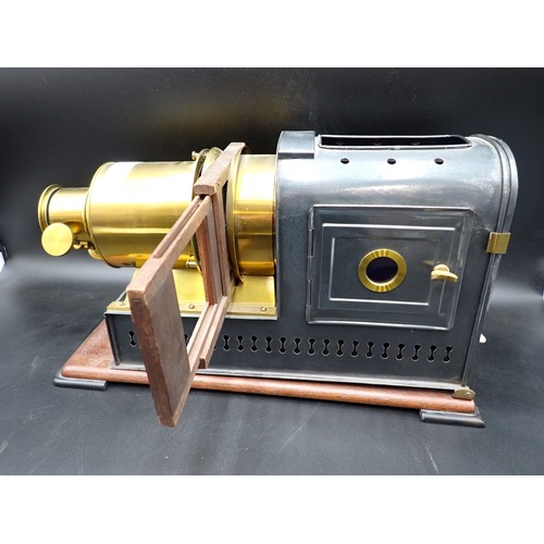 51 - A brass and japanned metal Magic Lantern on mahogany platform base, 17in; plus a quantity of reprodu... 