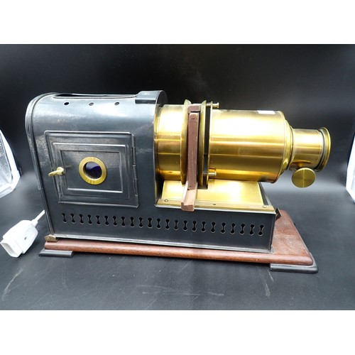 51 - A brass and japanned metal Magic Lantern on mahogany platform base, 17in; plus a quantity of reprodu... 