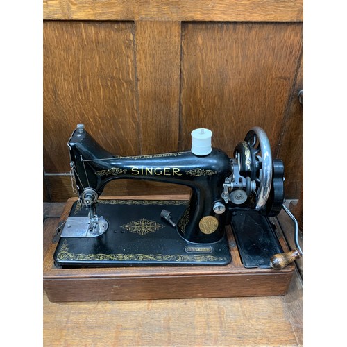 236 - An oak cased Singer Sewing Machine