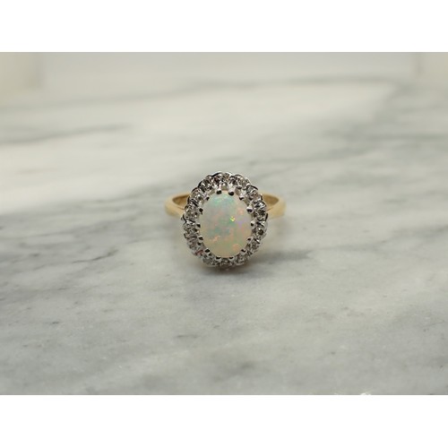 160 - An Opal and Diamond Cluster Ring claw-set oval opal cabochon within frame of eight-cut diamonds, sta... 