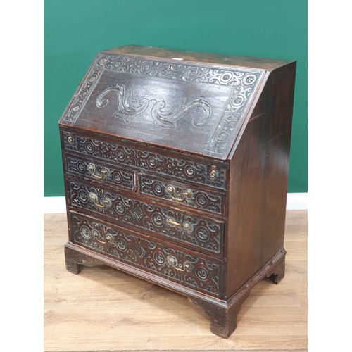 513 - An antique carved oak Bureau fitted two short and two long drawers 3ft 4in H x 2ft 11in W