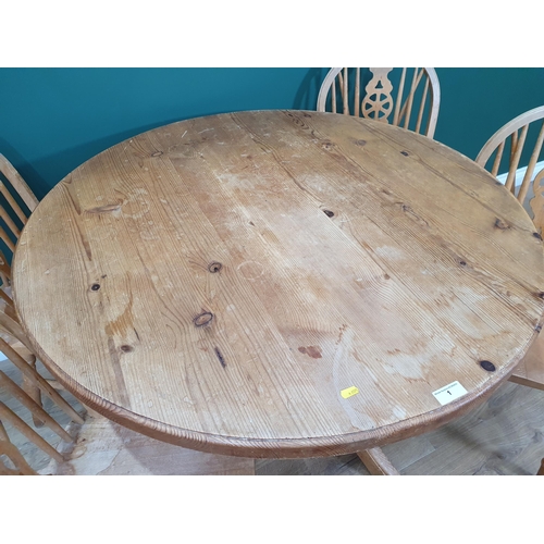 1 - A modern Pine circular Kitchen Table and four Wheelback Kitchen Chairs.