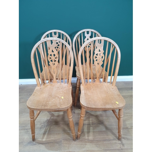 1 - A modern Pine circular Kitchen Table and four Wheelback Kitchen Chairs.