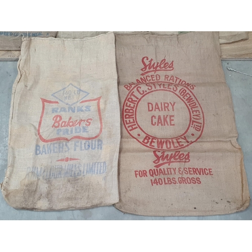 10 - Five hessian Sacks with various advertising logos (some repairs).