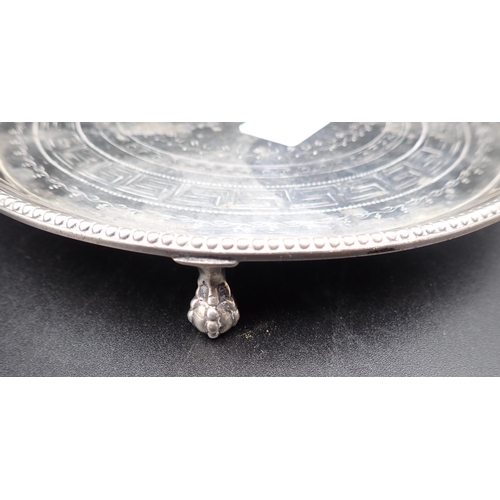 120 - A Victorian silver circular Salver with Greek key engraving and beaded rim on three ball and claw fe... 