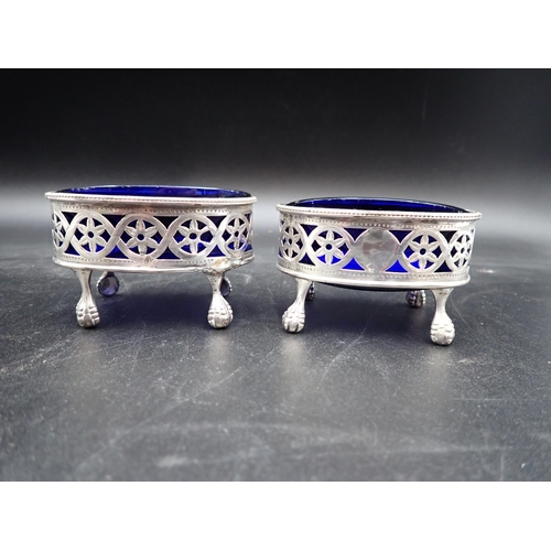 130 - A pair of George III silver pierced oval Salts with beaded rims, ball and claw feet, blue glass line... 