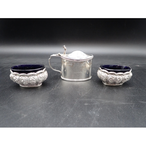 131 - A pair of Victorian silver oval Salts with scroll embossing and blue glass liners, Birmingham 1897, ... 