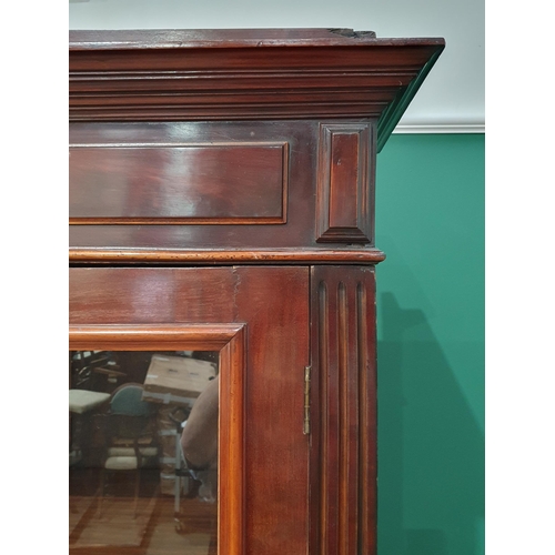 17 - A mahogany Bookcase the moulded cornice above pair of glazed doors with four adjustable shelves, abo... 