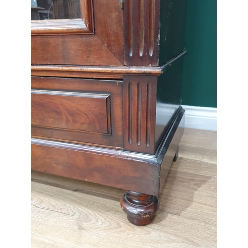 17 - A mahogany Bookcase the moulded cornice above pair of glazed doors with four adjustable shelves, abo... 