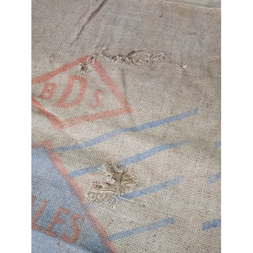 20 - Five hessian Sacks with various advertising logos (some repairs).