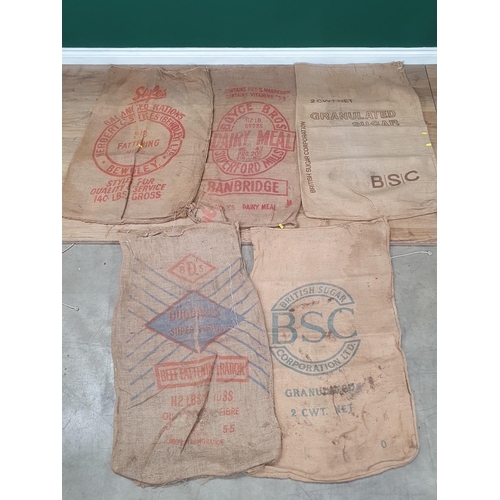 21 - Five hessian Sacks with various advertising logos (some repairs).