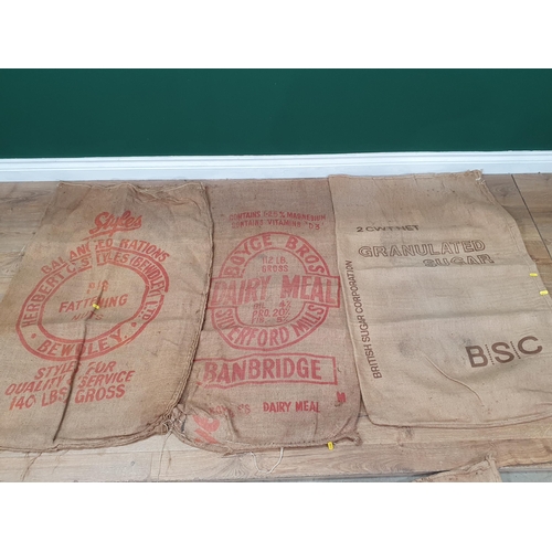 21 - Five hessian Sacks with various advertising logos (some repairs).