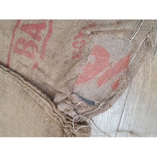 21 - Five hessian Sacks with various advertising logos (some repairs).