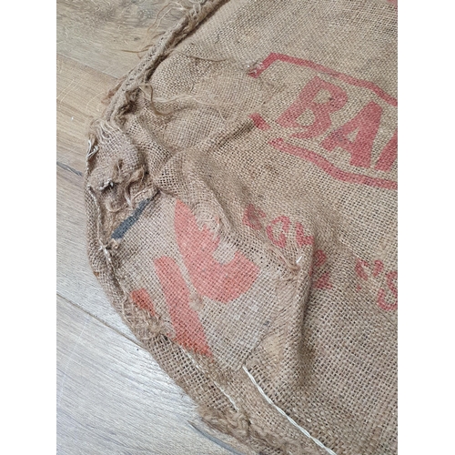 21 - Five hessian Sacks with various advertising logos (some repairs).