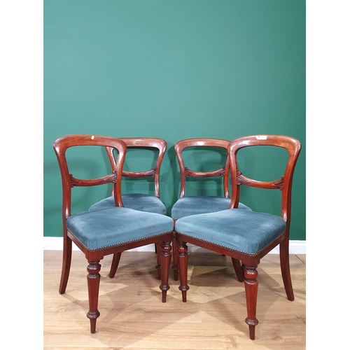 26 - A set of four Mahogany balloon back Dining Chairs with blue upholstered seats.