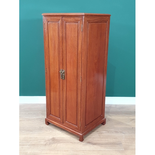 29 - A oriental hardwood Collectors Cabinet, the pair of panelled doors enclosing twenty glass lidded dra... 