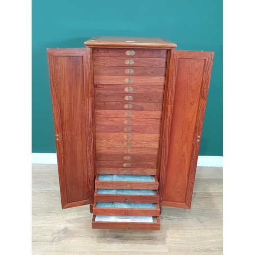 29 - A oriental hardwood Collectors Cabinet, the pair of panelled doors enclosing twenty glass lidded dra... 