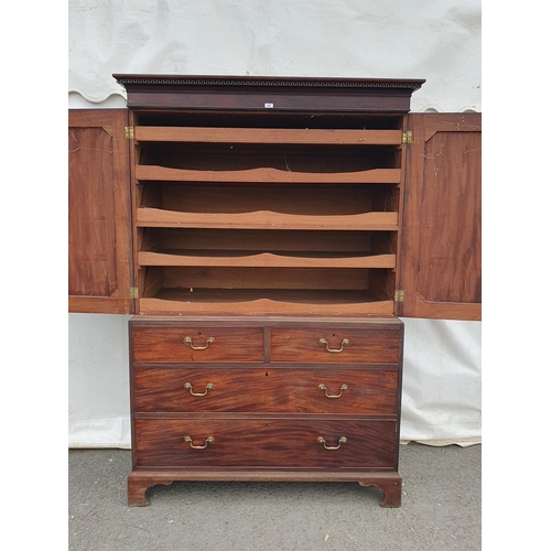 298 - A 19th Century mahogany Linen Press with dentil cornice above a pair of  panelled doors enclosing sl... 