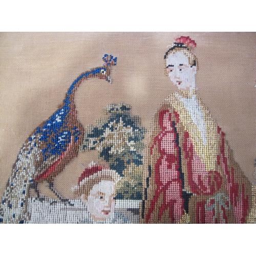 415 - A 19th Century embroidered wool work depicting Eastern figures and a peacock, 17 x 21in