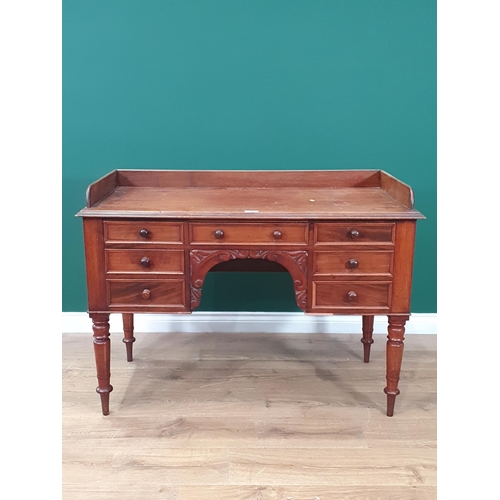 45 - A mahogany Writing Desk with raised gallery, seven fitted drawers on turned and tapered supports, A/... 