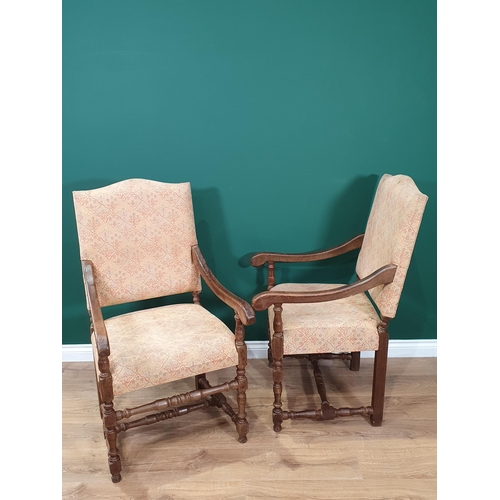 459 - A set of four beige floral upholstered oak Elbow Chairs on turned supports and stretchers.