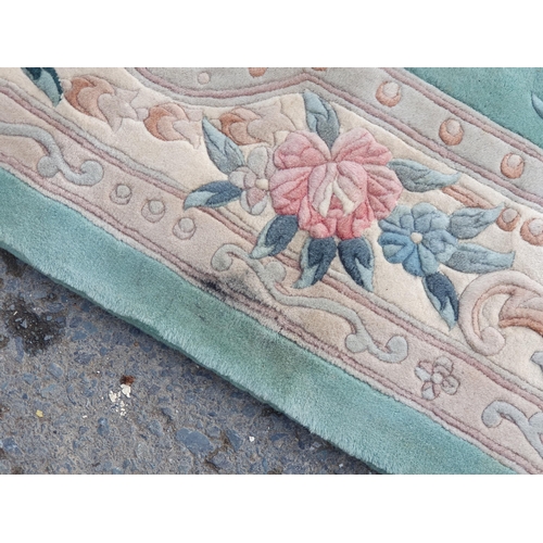 460 - A blue ground Rug with floral border and central floral motif, 10ft 10