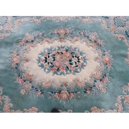 460 - A blue ground Rug with floral border and central floral motif, 10ft 10